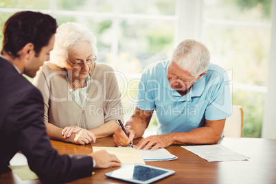 Senior man signing document