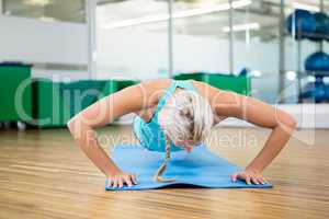 Fit blonde doing push up on mat