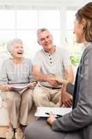 Businesswoman talking with senior couple