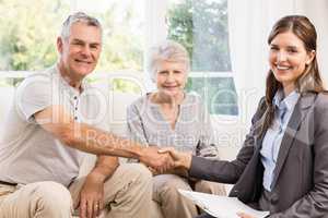 Businesswoman and senior man handshaking