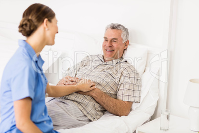 Nurse taking care of suffering senior patient