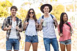 Hip friends walking and holding a map