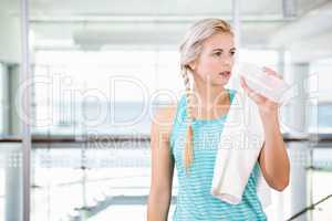 Smiling blonde drinking water