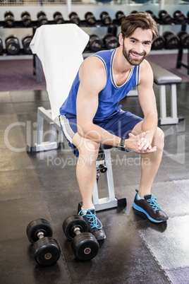 Smiling man sitting on bench