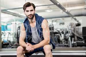 Handsome man sitting in the gym