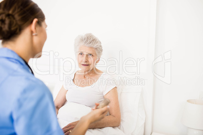 Nurse taking care of suffering senior patient