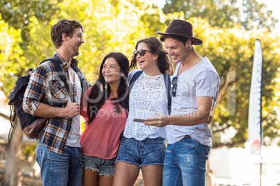 Hip friends looking at smartphone