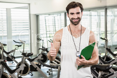 Smiling trainer showing thumb up