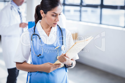 Nurse reading her files