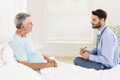 Handsome nurse visiting a mature man