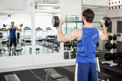 Muscular man lifting barbell