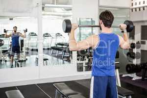 Muscular man lifting barbell