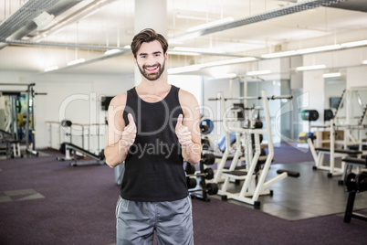 Smiling man showing thumbs up