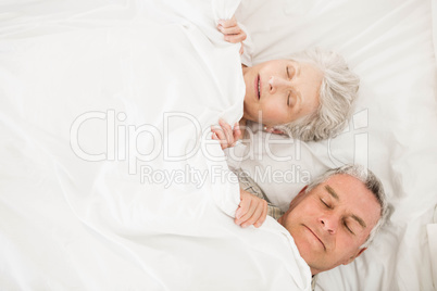 Senior couple sleeping in bed