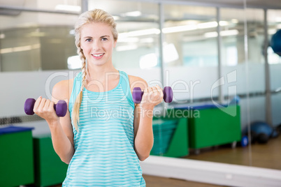 Fit woman lifting dumbbells