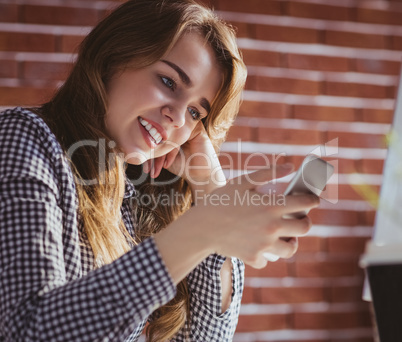 Young hipster businesswoman using her phone