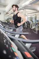 Handsome man running on treadmill