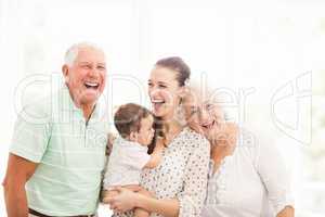 Happy grandparents playing with their grandson