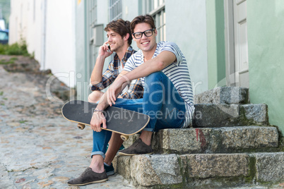 Hip men sitting on steps