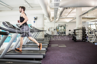Handsome man running on treadmill