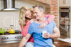 Happy couple holding mugs