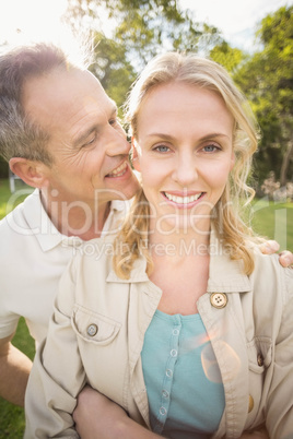Husband whispering something to wifes ears