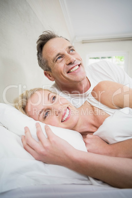 Cute couple cuddling in bed