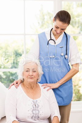 Nurse taking care of sick elderly woman