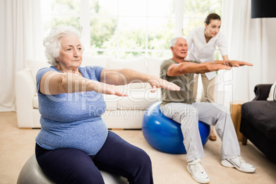 Physiotherapist helping patients with exercises