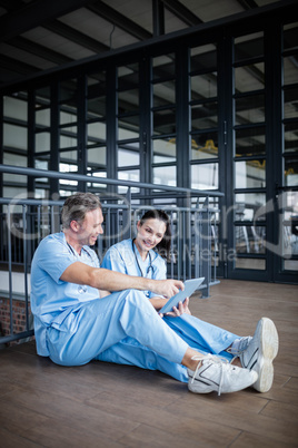 Two nurses sitting on floor and talking