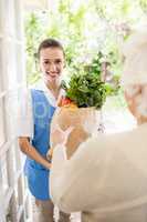 Nice nurse bringing vegetables to old patient