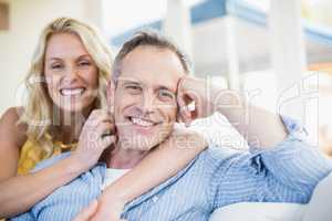 Happy couple hugging on the couch