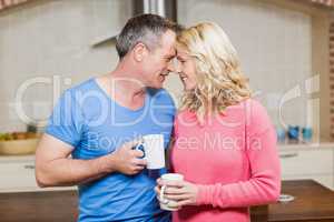 Happy couple holding mugs