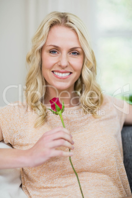 Pretty woman smelling a rose