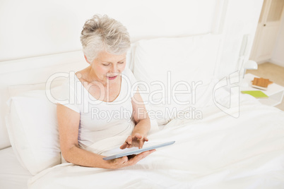 Smiling woman using tablet