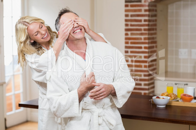 Woman covering her husband eyes