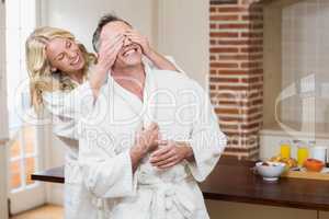 Woman covering her husband eyes