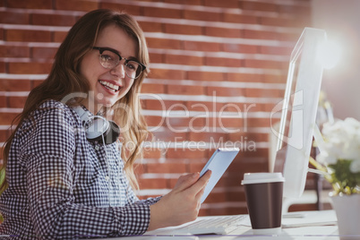 Smiling hipster businessman using tablet