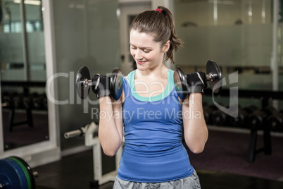 Fit woman lifting dumbbells