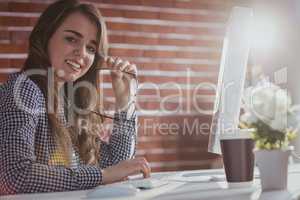 Smiling hipster businesswoman watching computer