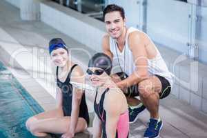 Trainer and swimmers smiling at the camera