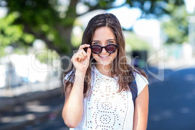 Hip girl holding her sunglasses