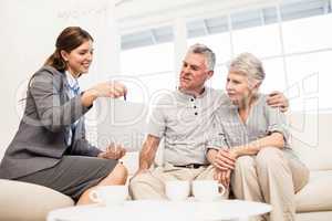 Businesswoman showing documents to senior couple