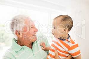 Senior man playing with his grandson