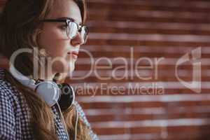Focused hipster businesswoman with headphone