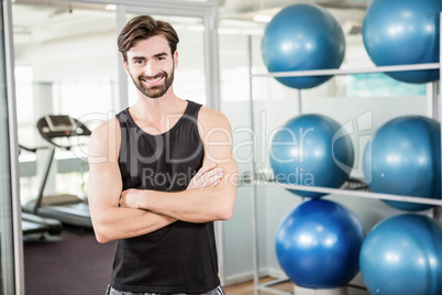 Smiling man standing with arms crossed