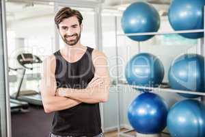 Smiling man standing with arms crossed