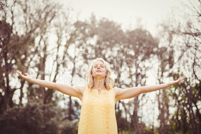 Happy woman with arms raised