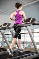 Fit brunette running on treadmill