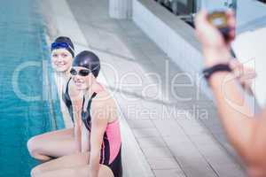 Smiling swimmers looking at trainer